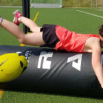 Child tackling a tackle bag
